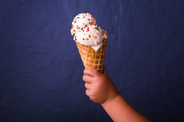 child holding an ice cream cone in Missouri Ice Cream Shop
