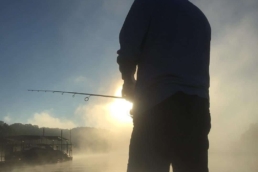 Bass fisherman on Lake of The Ozarks in the Missouri Sunrise