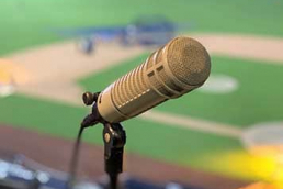 Microphone in baseball press box overlooking an infield.