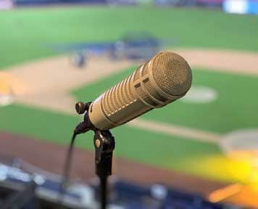 Microphone in baseball press box overlooking an infield.