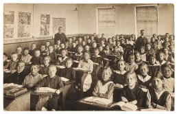 Old school room with crowd of students seated.