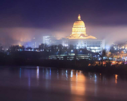 Missouri Capitol building at night with reflection off the Missouri River.