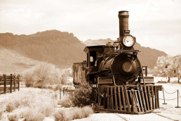 An old locomotive on the railroad tracks.