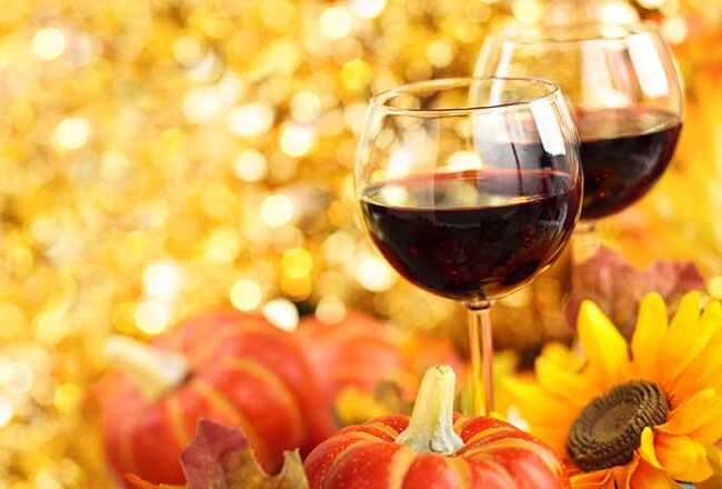 The glasses of red wine with a colorful autumn surrounding.