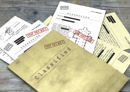 Important documents and folders marked Classified and Top Secret.