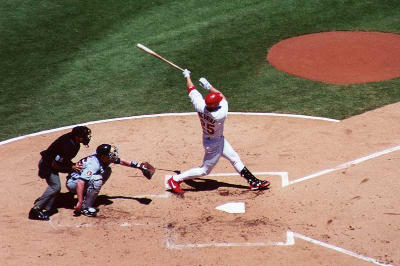 St. Louis Cardinals baseball player hitting a home run in Busch Stadium