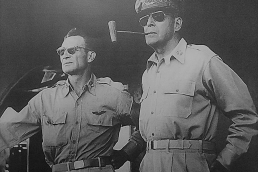 General MacArthur standing with soldier