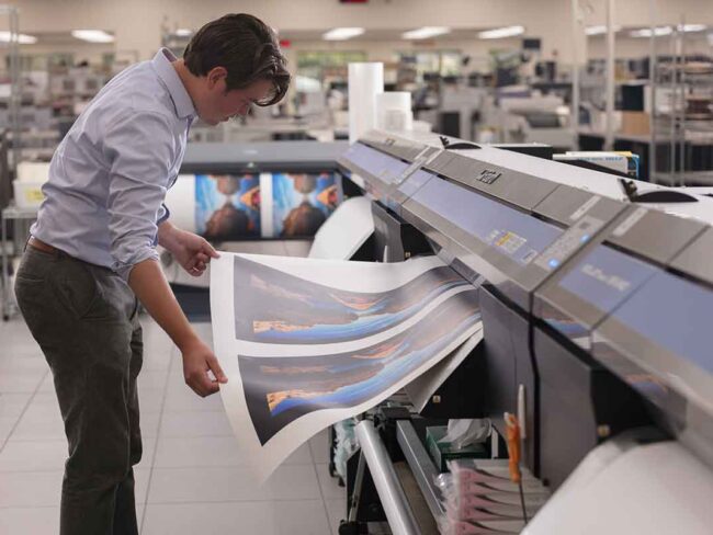 Man looking at large printed artwork in Missouri Printing Facility