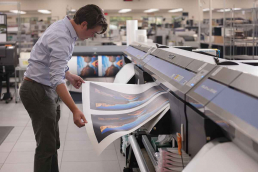 Man looking at large printed artwork in Missouri Printing Facility
