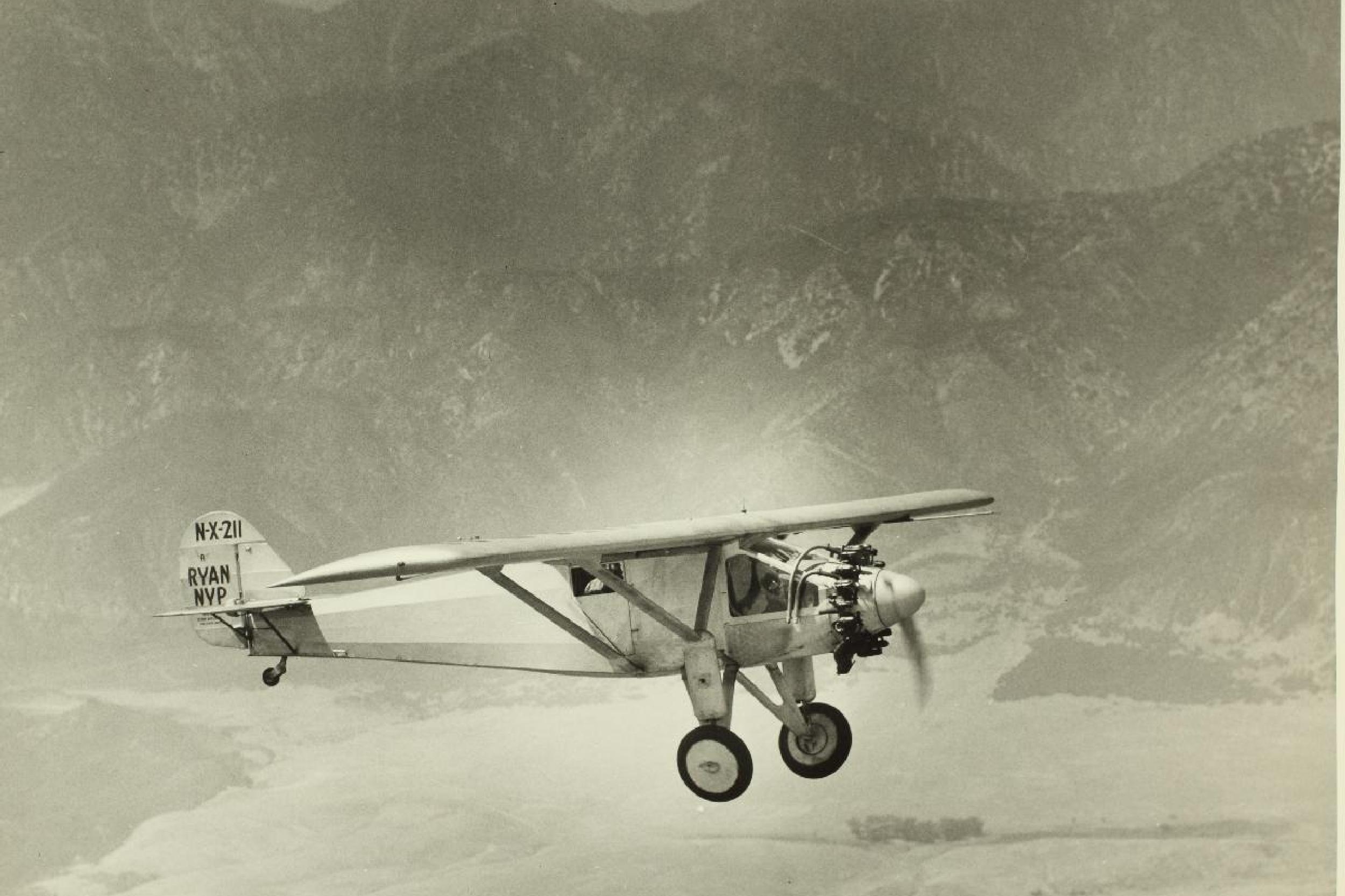 Old airplane flying through the mountains