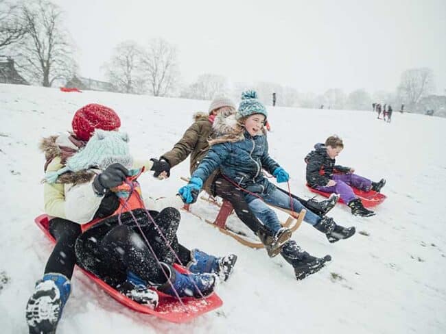Kids sledding on Art Hill. AdobeStock photo