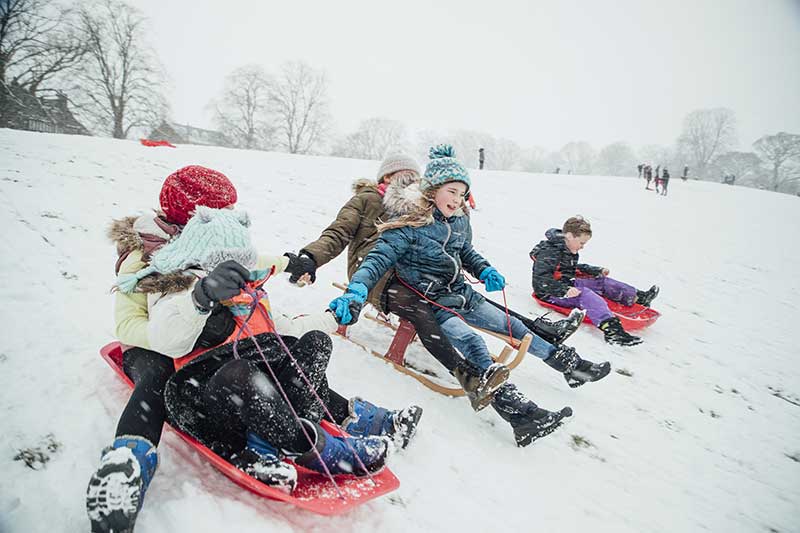 Kids sledding on Art Hill. AdobeStock photo