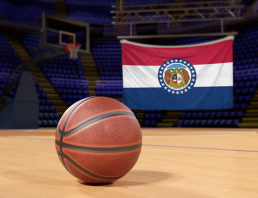 A basketball with the Missouri State Flag in the background.