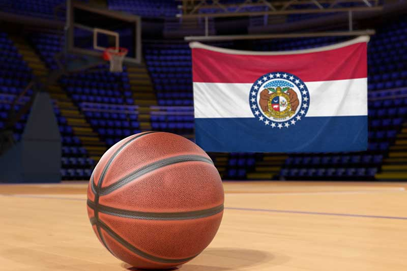 A basketball with the Missouri State Flag in the background.