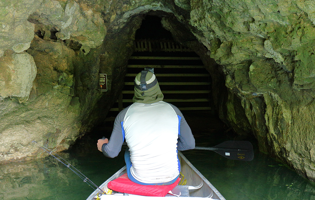 Matt at the entrance of a cave that is closed off on Upper Jacks Fork