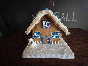 A gingerbread house decorated in Kansas City Royals color and theme.